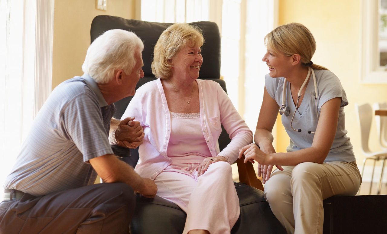 Hospice Nurse Talking to Couple --- Image by © Corbis