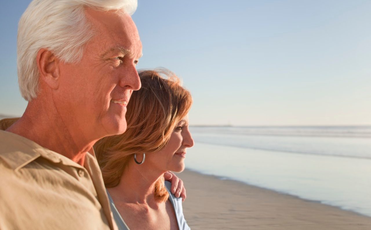 Middle aged couple on beach --- Image by © Patrick Lane/Corbis