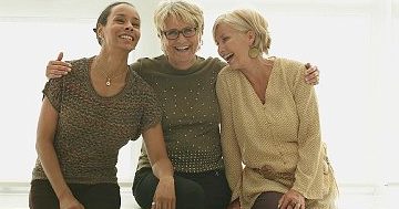 09 May 2013 --- Smiling women hugging on bench --- Image by © LWA/Dann Tardif/Blend Images/Corbis