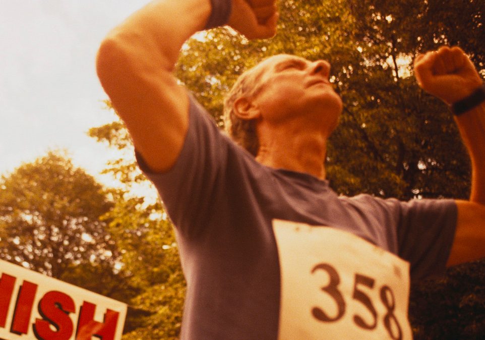 CSM102902 Elderly Runner Crossing Finish Line --- Image by © Dann Tardif/LWA/Corbis