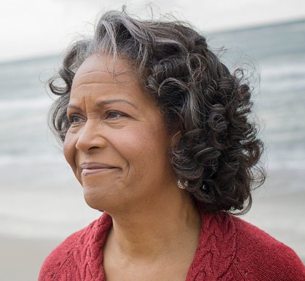 Portrait of elderly woman on beach --- Image by © Hiya Images/Corbis