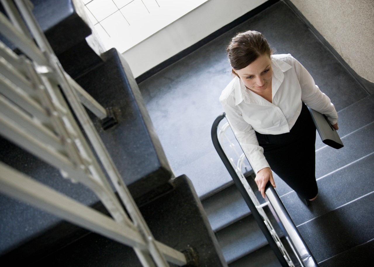 Woman walking up stairs --- Image by © Andersen Ross/cultura/Corbis