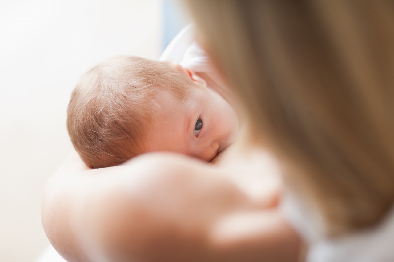 Cape Town, South Africa --- Above view of newborn getting breastfed --- Image by © Wavebreak Media Ltd./Corbis