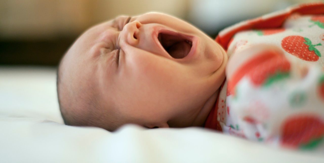 0042-11-30T00:00:00.000Z Two month old baby lying down yawning --- Image by © MKeal/Corbis