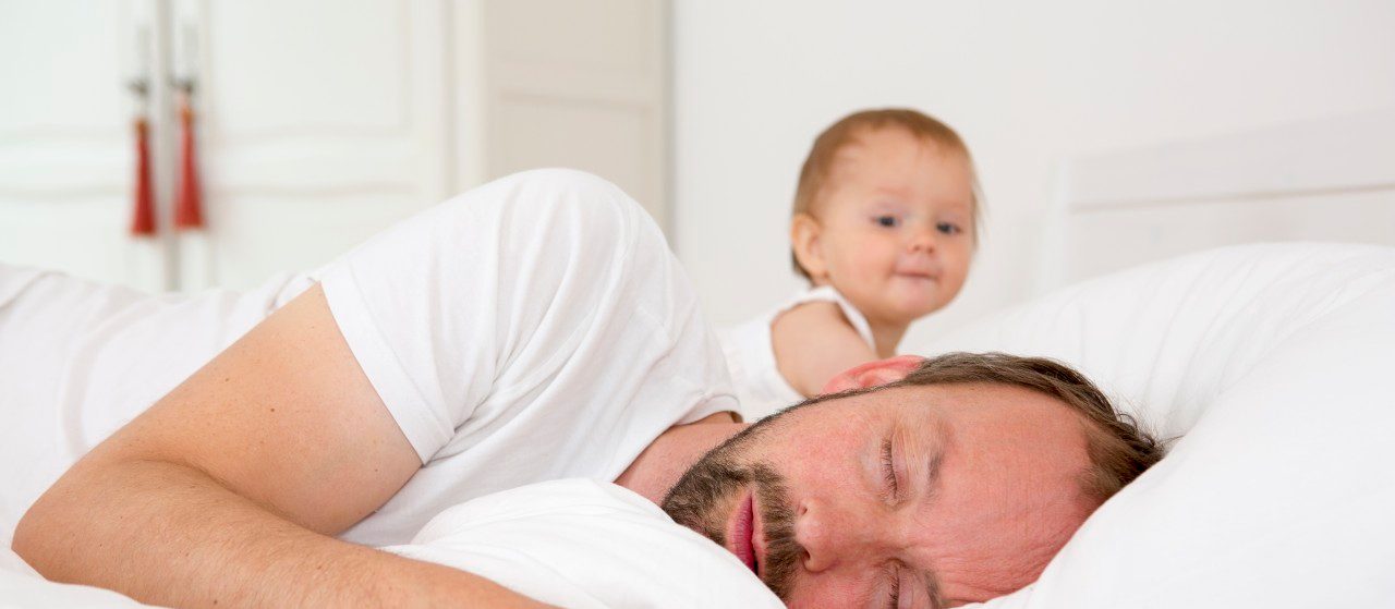 0042-11-30T00:00:00.000Z 13 Jul 2014 --- Father asleep in bed, baby daughter watching --- Image by © Judith Haeusler/Corbis