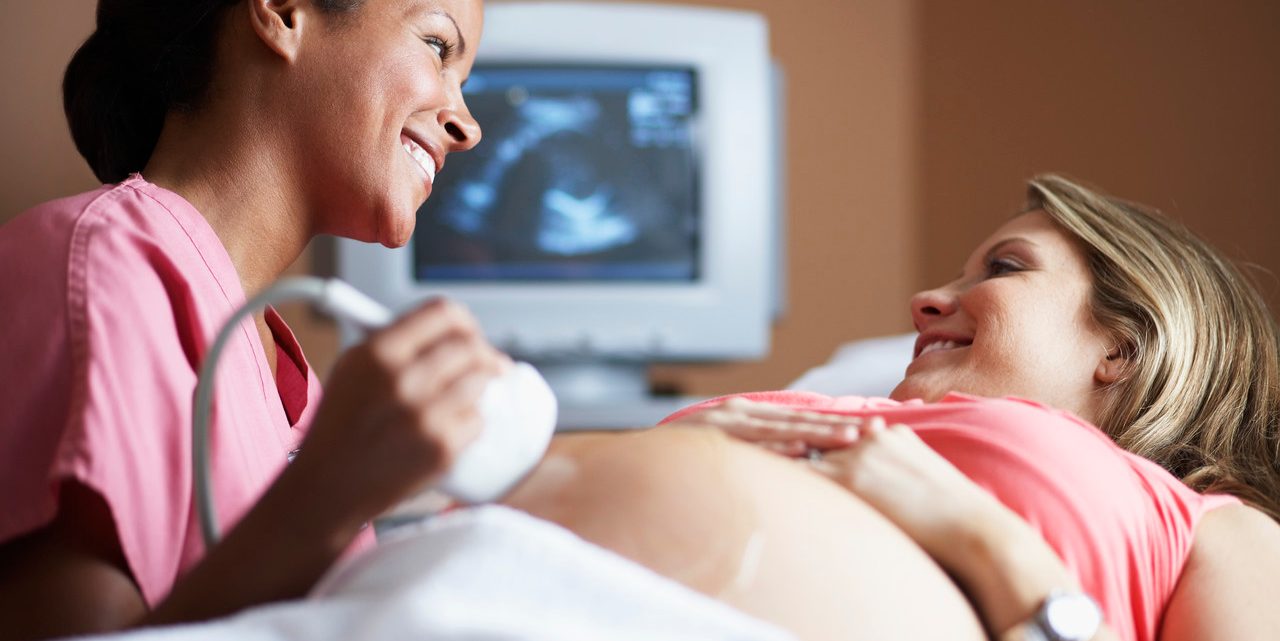 Nurse Conducting Ultrasound Examination --- Image by © Sean Justice/Corbis