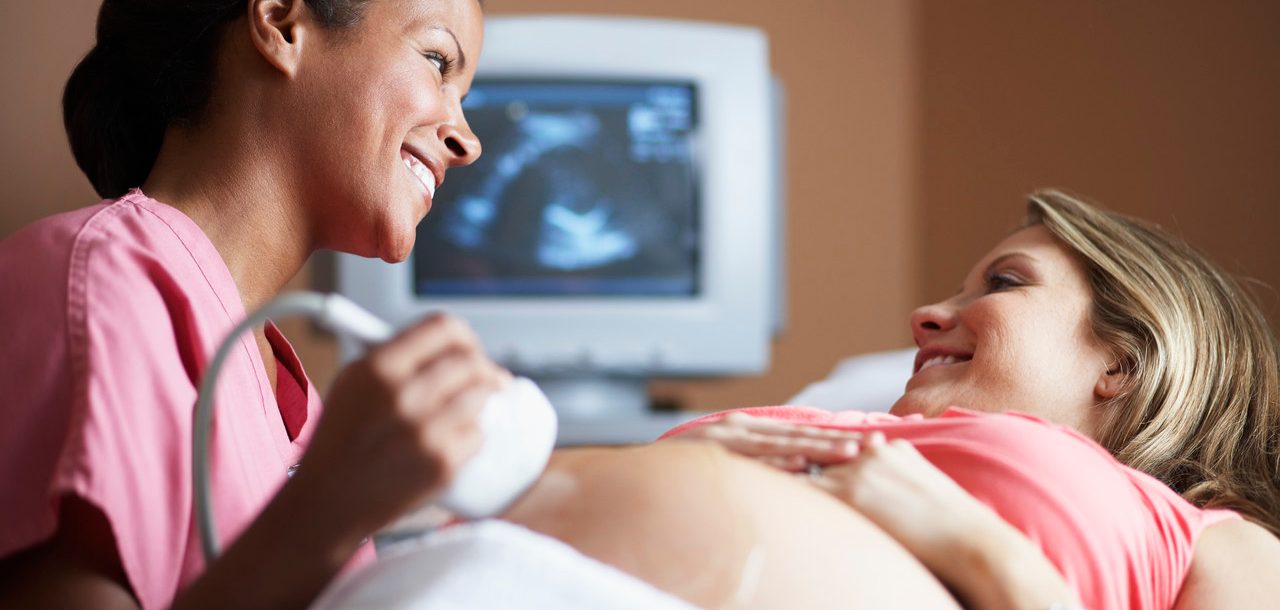 Nurse Conducting Ultrasound Examination --- Image by © Sean Justice/Corbis