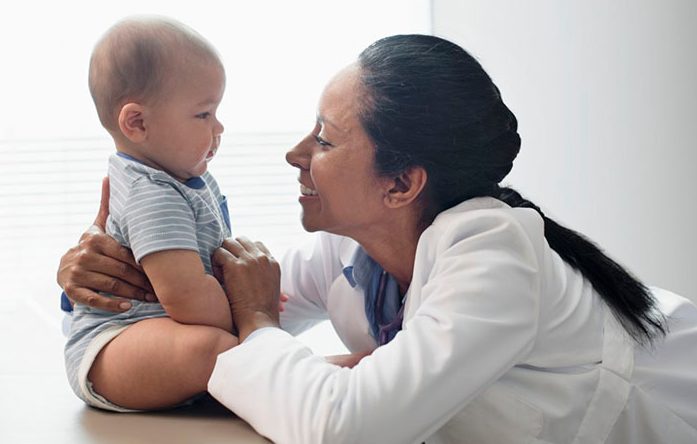 Pediatrician with baby girl (2-5 months) --- Image by Â© Hiya Images/Corbis