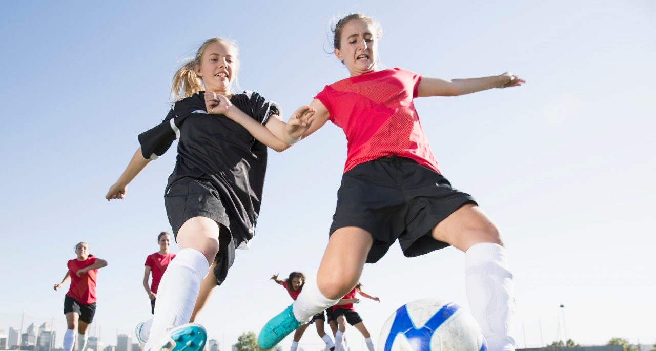 21 Sep 2012 --- Soccer girls racing for soccer ball. --- Image by © Hero Images/Corbis