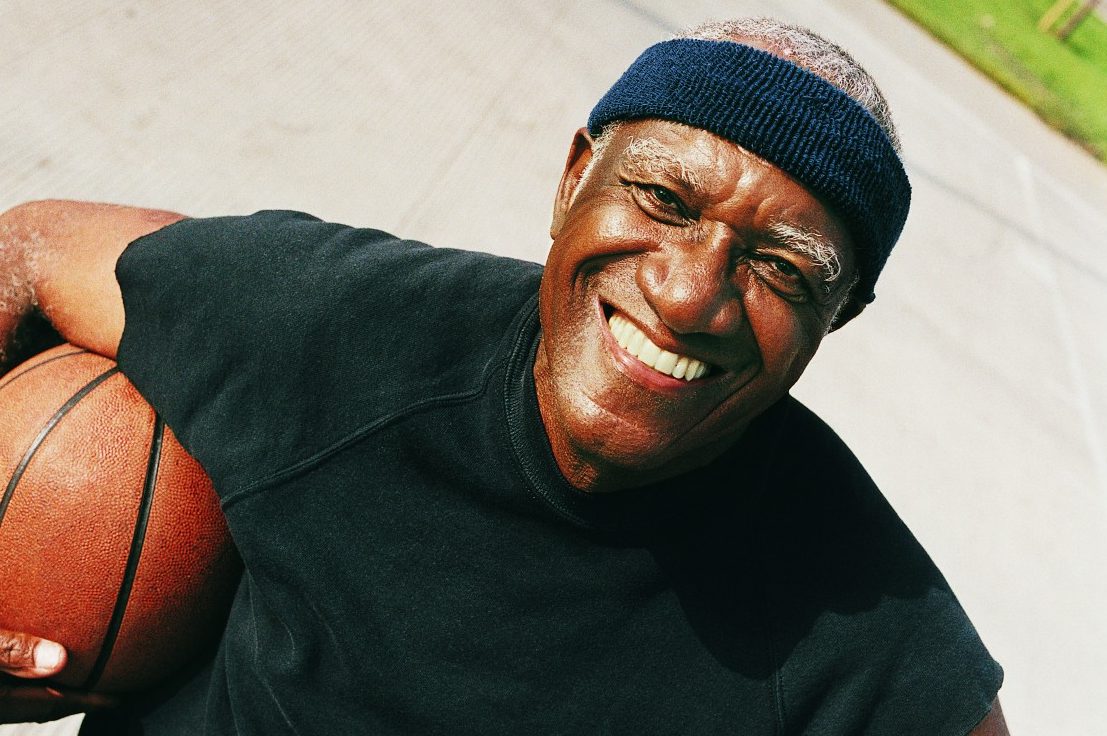 Elevated View of an Elderly Man Standing Holding a Basketball --- Image by © 2/Ocean/Corbis