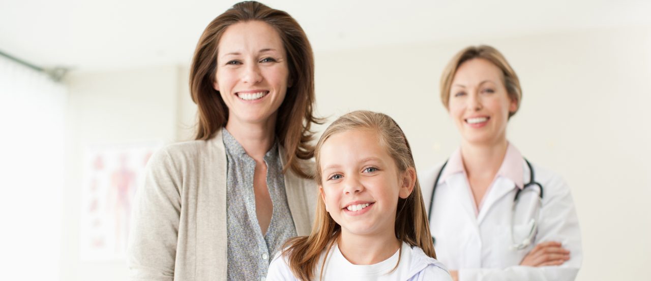 Doctor, mother and daughter in doctorÃ ?s office