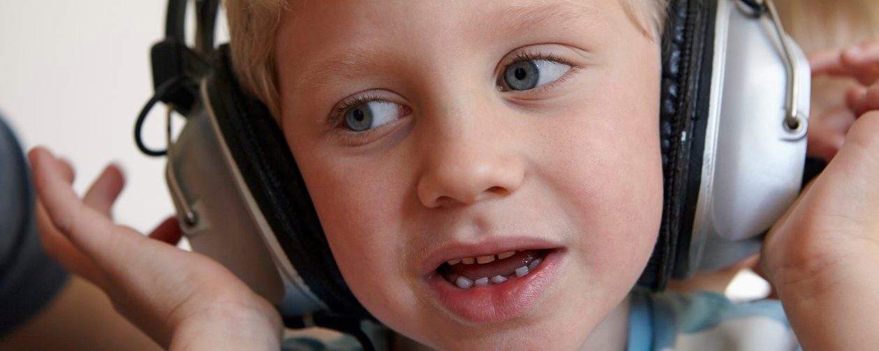 31 Jan 2015 --- Little boy listening to music with headphones --- Image by © Rainer Holz/Westend61/Corbis
