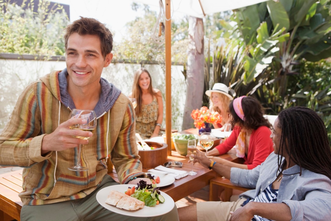 Friends dining at outdoor table --- Image by © Laura Doss/Corbis