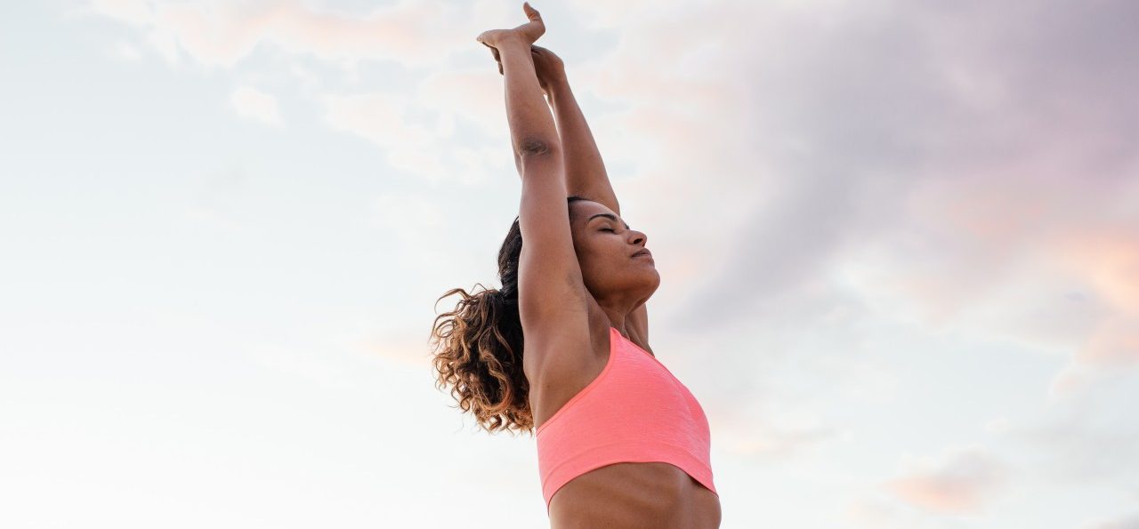 0042-11-30T00:00:00.000Z 04 Sep 2014, Italy --- Young woman stretching arms on beach, Tuscany, Italy --- Image by © Sofie Delauw/Corbis