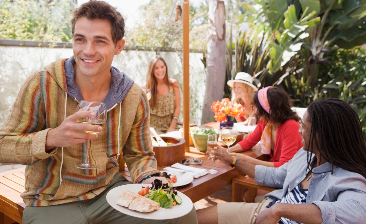 Friends dining at outdoor table --- Image by © Laura Doss/Corbis