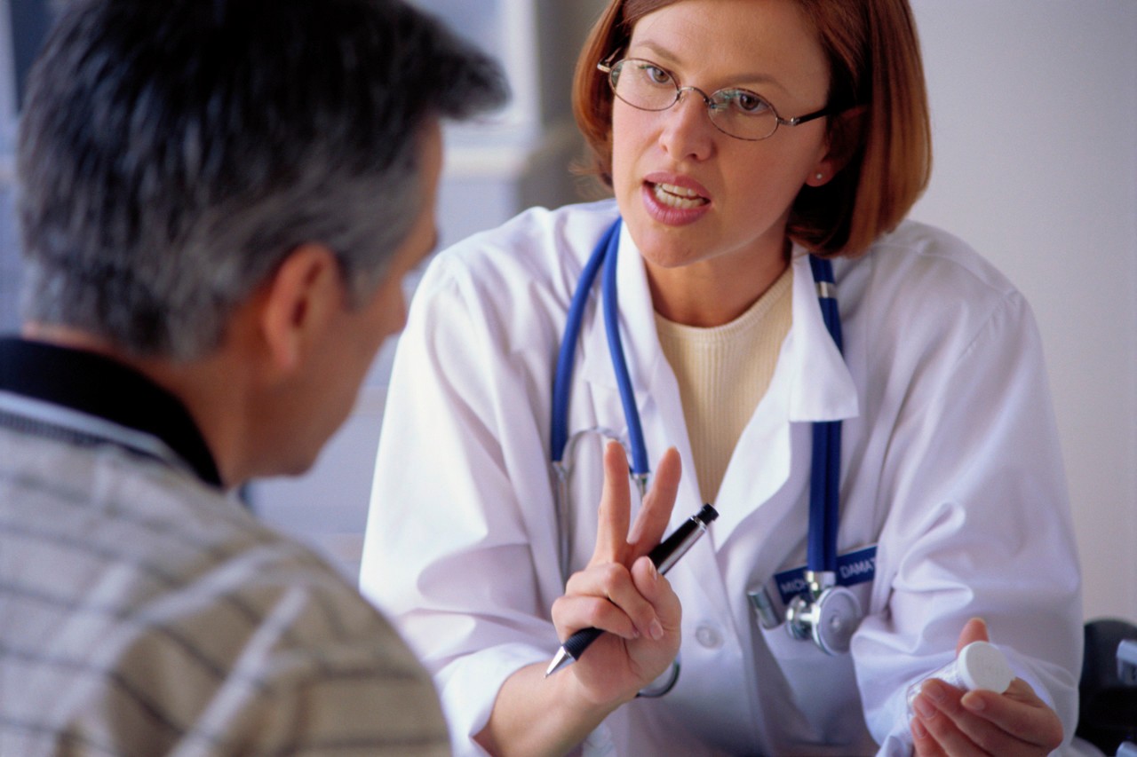 Physician Consulting Patient --- Image by © Stephen Welstead/LWA/Corbis