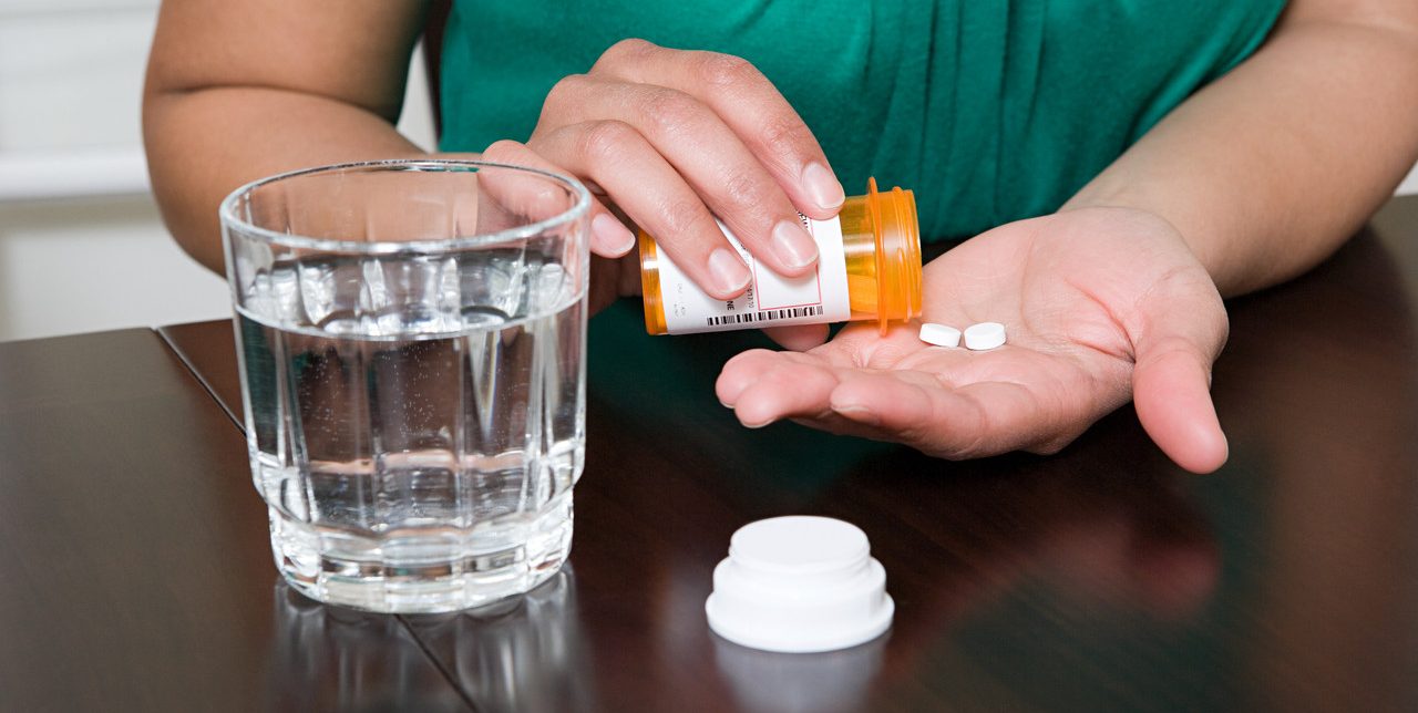 0042-11-30T00:00:00.000Z Woman Taking Tablets --- Image by © Image Source/Corbis