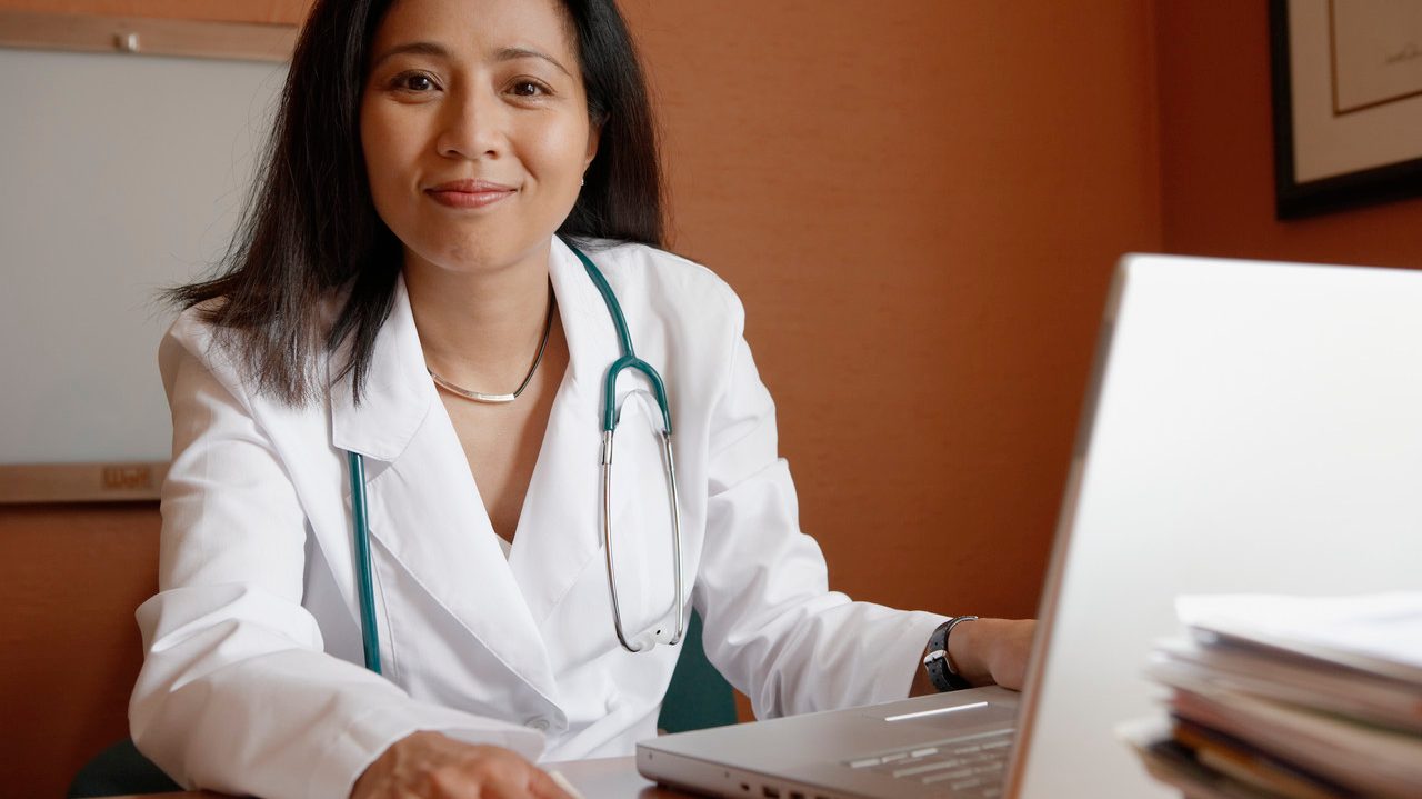 0042-11-30T00:00:00.000Z Doctor in Office at Clinic --- Image by © Charles Gullung/Corbis