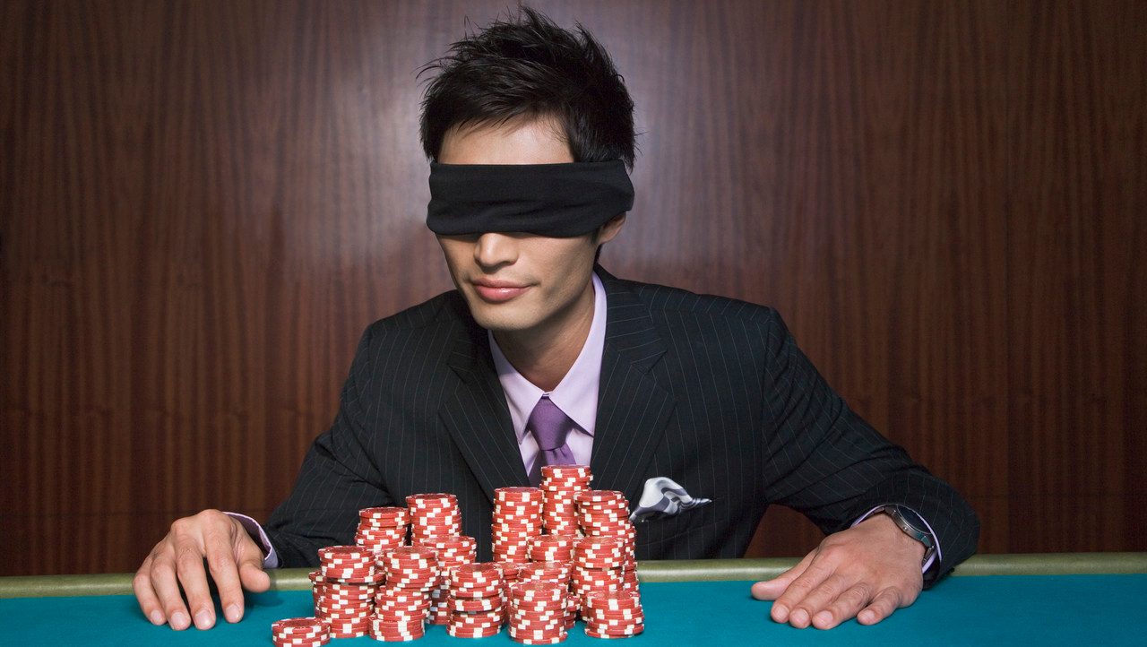 Blindfolded Young Man at Casino --- Image by © Corbis