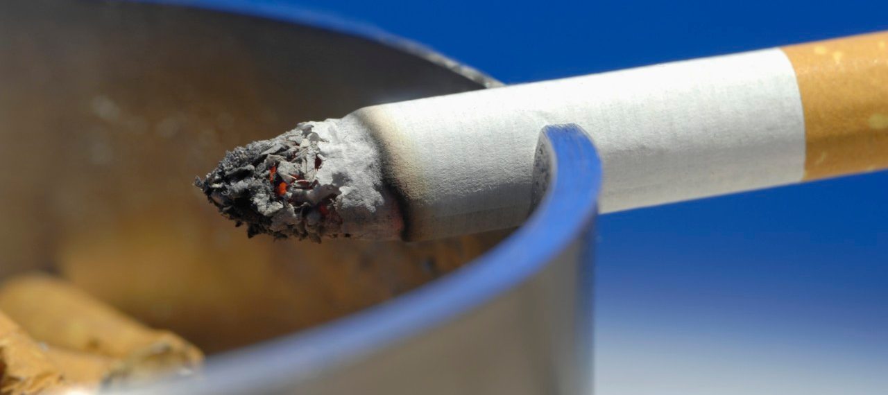 Cigarette on ashtray, close up --- Image by © Claudia Rehm/Westend61/Corbis