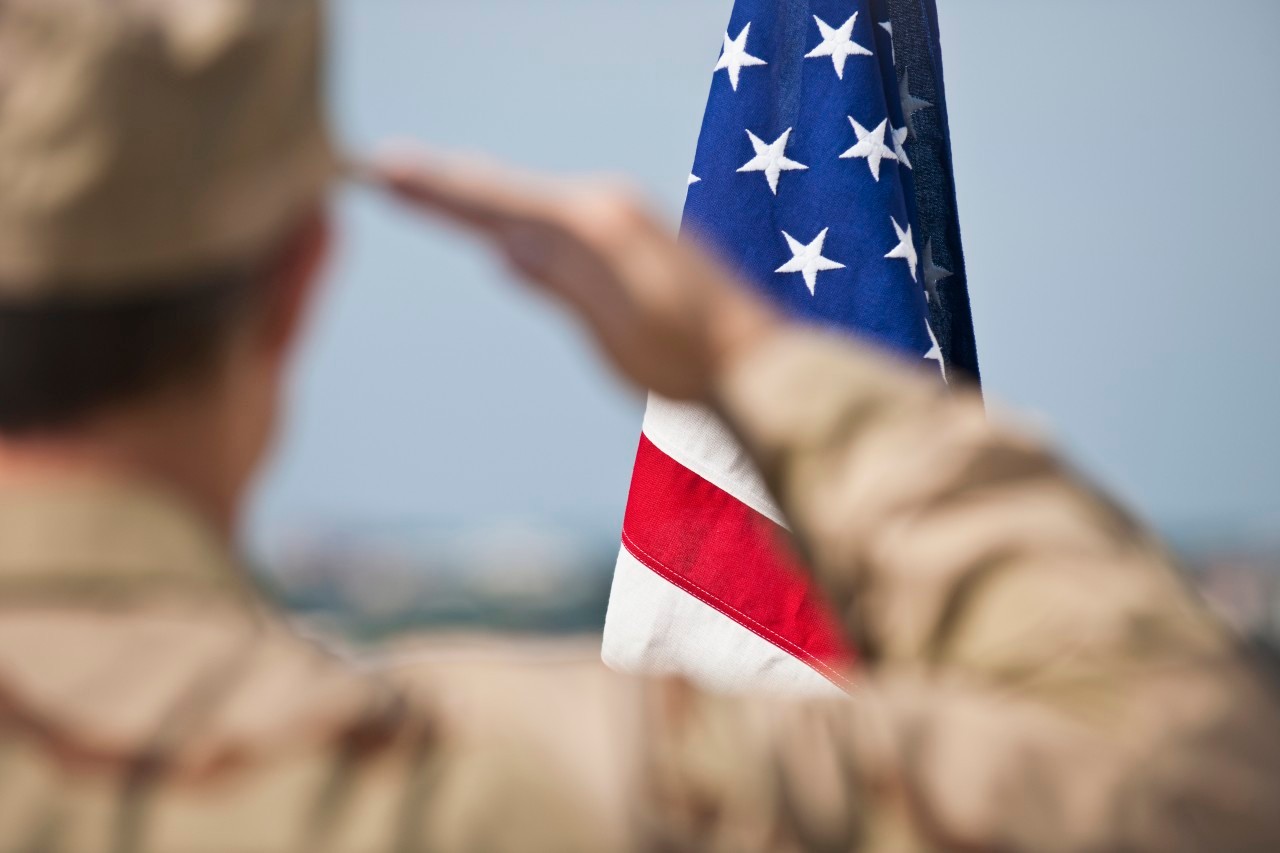 Soldier saluting --- Image by © Tetra Images/Corbis