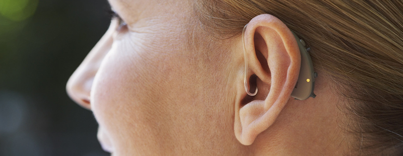 Close-up Of Woman's Ear with Hearing Aid --- Image by © Radius Images/Corbis