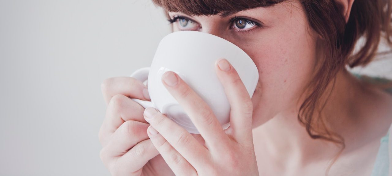 0042-11-30T00:00:00.000Z Young woman drinking tea --- Image by © Hannah Mentz/Corbis