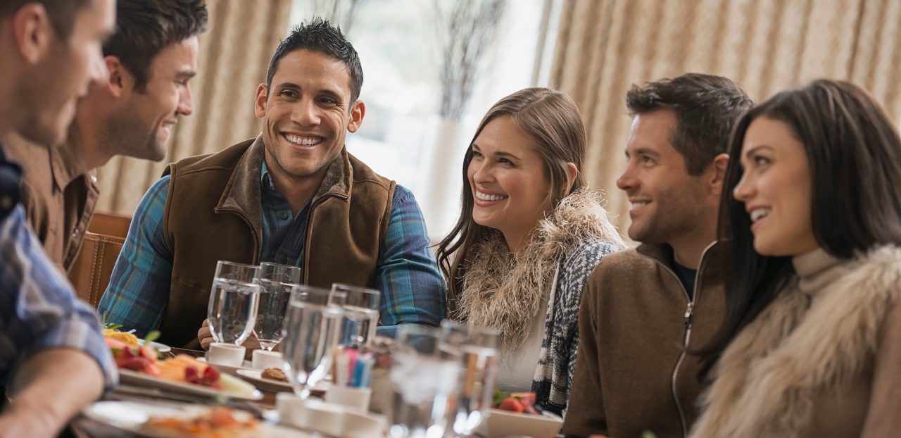 Group of friends having dinner at restaurant --- Image by © Hiya Images/Corbis