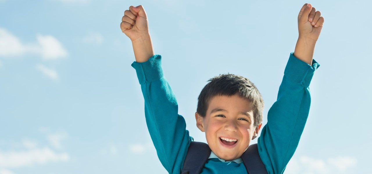 0042-11-30T00:00:00.000Z Boy (6-7) wearing backpack punching air --- Image by © Tetra Images/Corbis