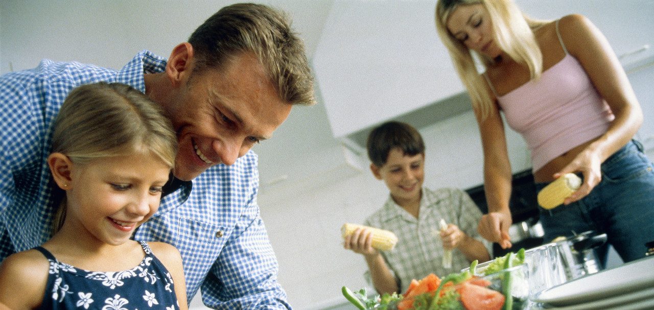 Family preparing the food, part of --- Image by © Alexander Scott/Corbis