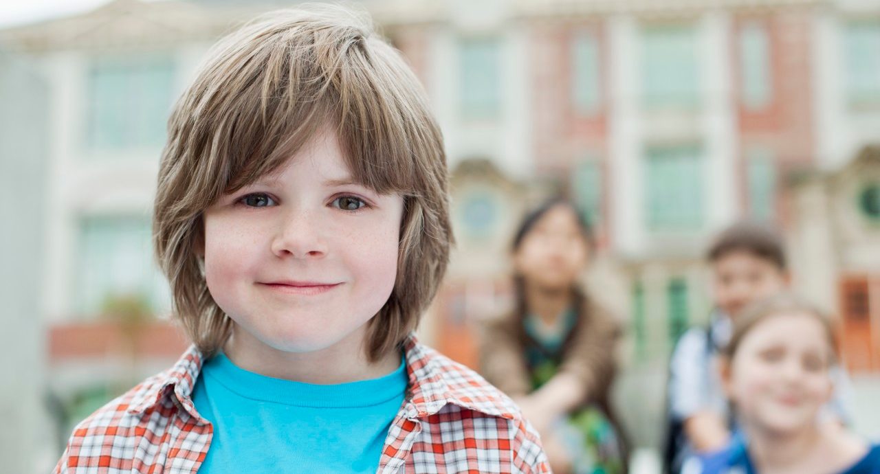 29 Apr 2012 --- Portrait of elementary student with classmates. --- Image by © Hero Images/Corbis