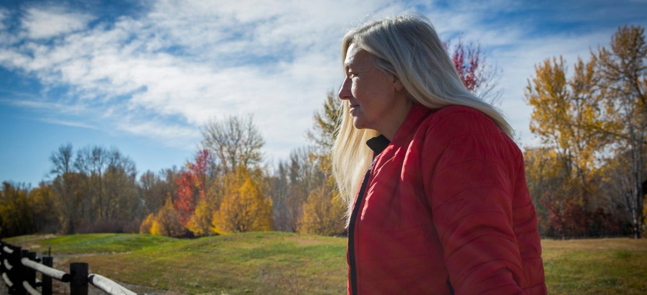 25 Oct 2014 --- Older Caucasian woman sitting on wooden fence --- Image by © Steve Smith/Blend Images/Corbis