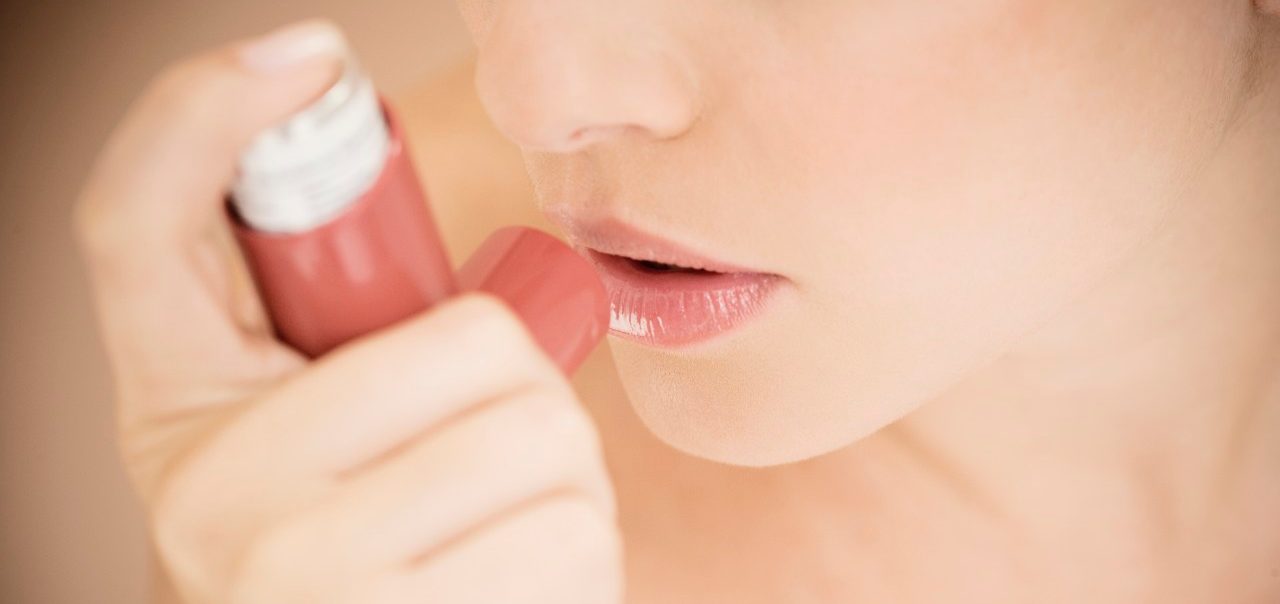 Female asthma sufferer using an inhaler --- Image by © I Love Images/Corbis
