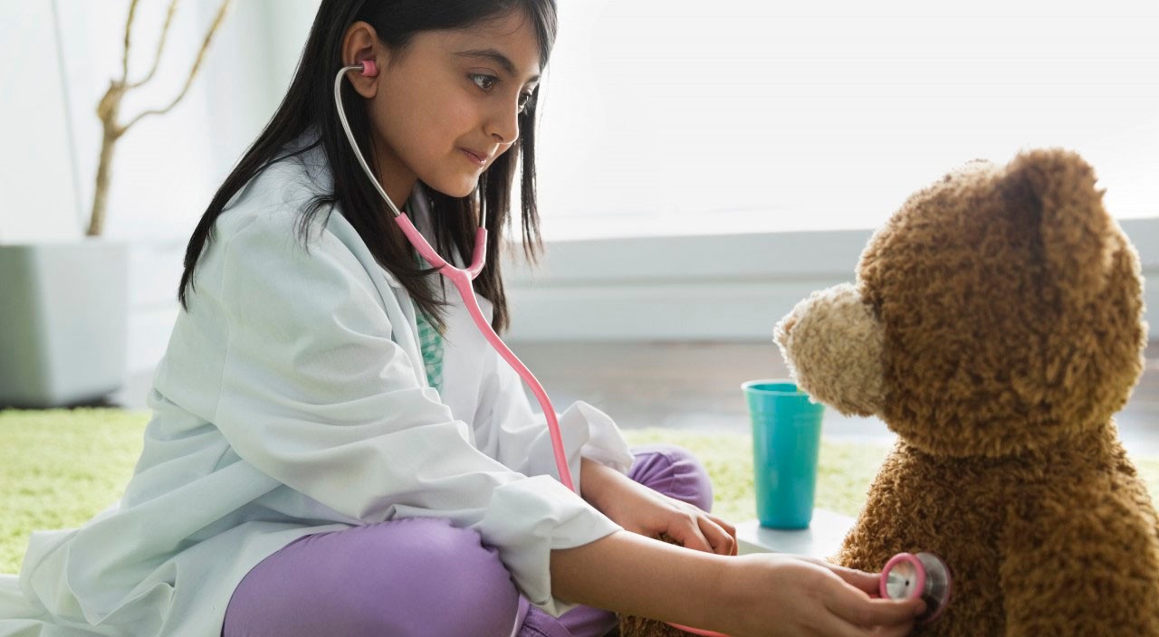 08 Mar 2013, Calgary, Alberta, Canada --- Girl pretending to be doctor --- Image by © Hero Images/Hero Images/Corbis