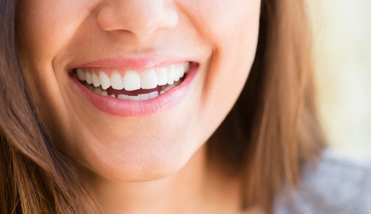 01 May 2014 --- Close up of woman's smile --- Image by © JGI/Jamie Grill/Blend Images/Corbis
