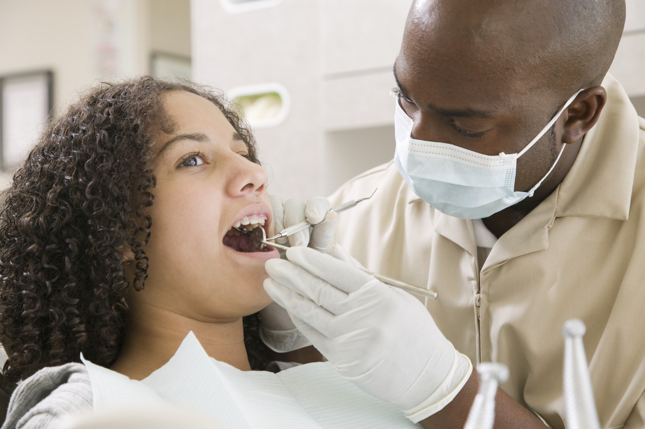 Dentist with Patient --- Image by © Lucidio Studio, Inc./Corbis