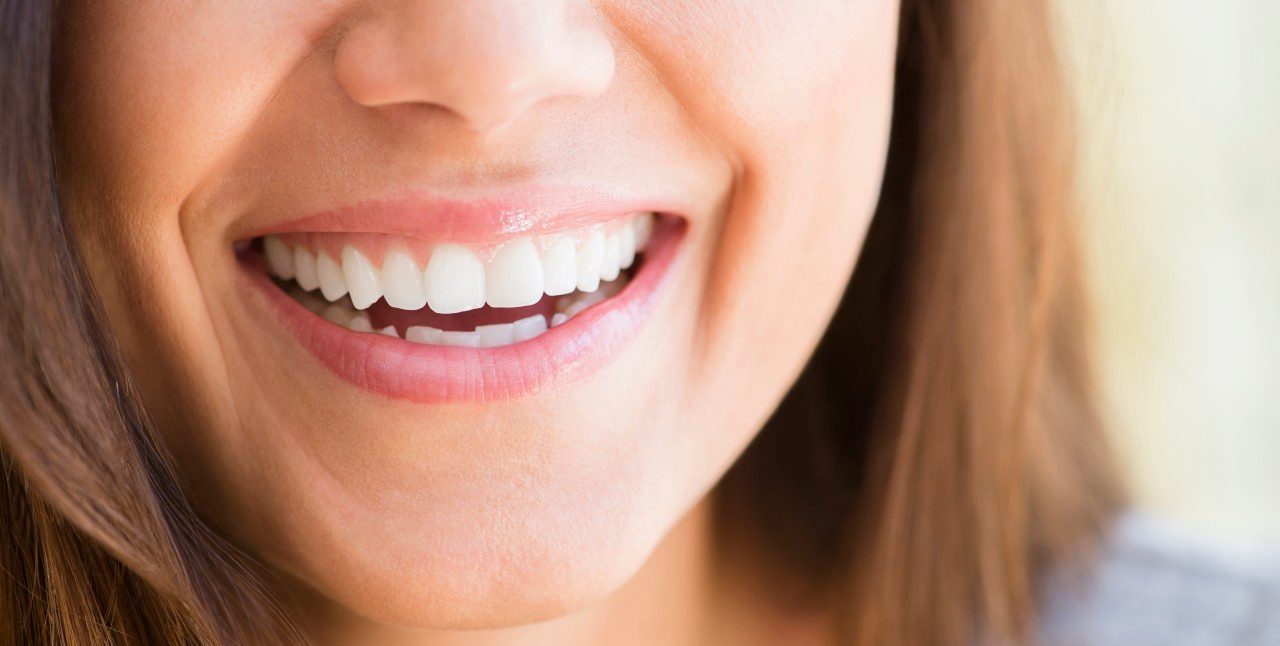 01 May 2014 --- Close up of woman's smile --- Image by © JGI/Jamie Grill/Blend Images/Corbis