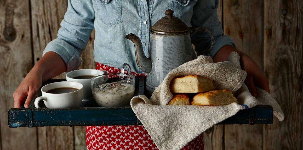 0042-11-30T00:00:00.000Z Girl holding tray of biscuits and gravy and coffee. --- Image by © Lew Robertson/Corbis