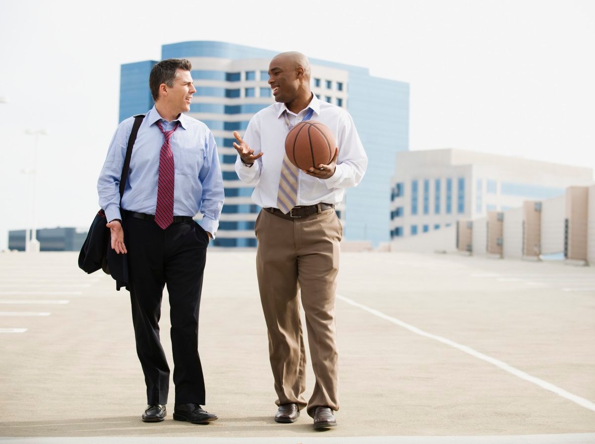 Businessman on their way to basketball game --- Image by © Erik Isakson/Tetra Images/Corbis