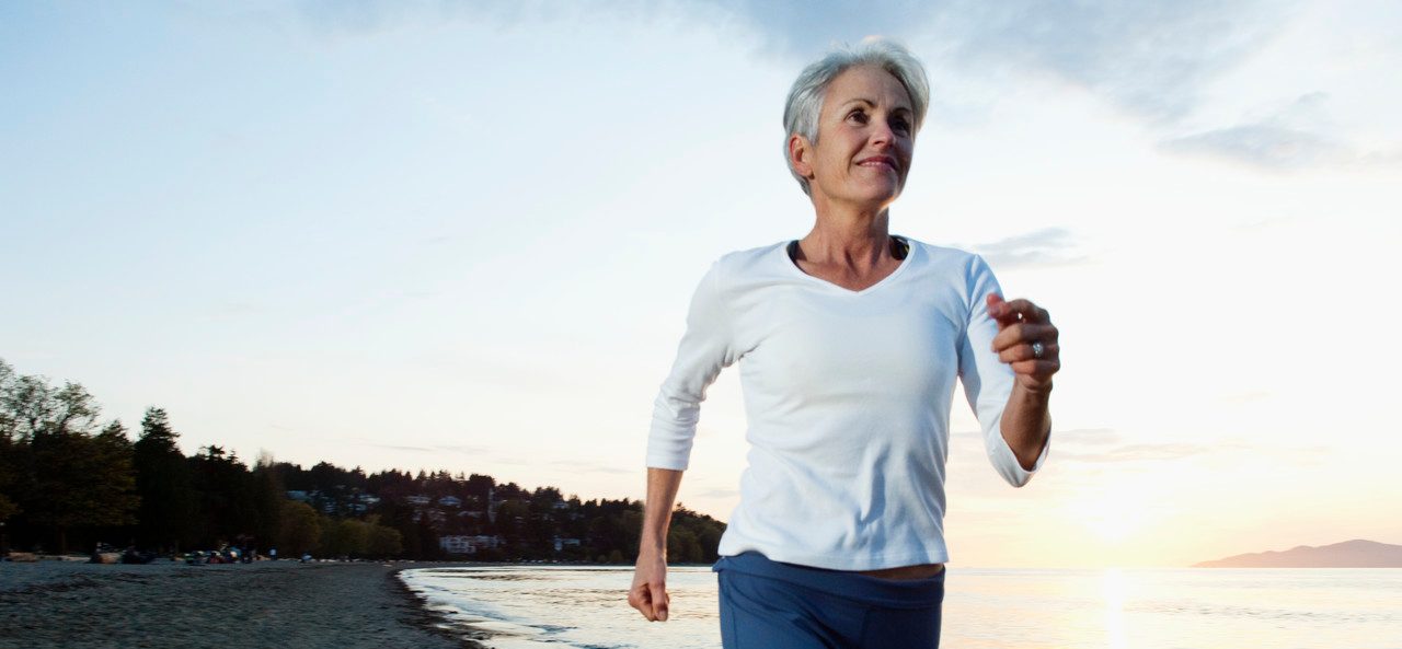 0042-11-30T00:00:00.000Z Woman running on beach --- Image by © Monalyn Gracia/Corbis