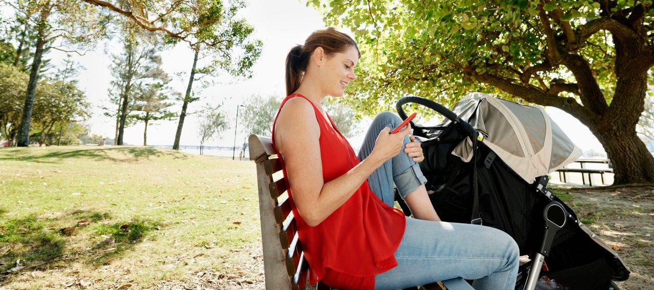 0042-11-30T00:00:00.000Z Young mother resting in the shade of the trees on a park bench, texting.Location Gold Coast, Queensland, Australia. --- Image by © Michael Pole/Corbis