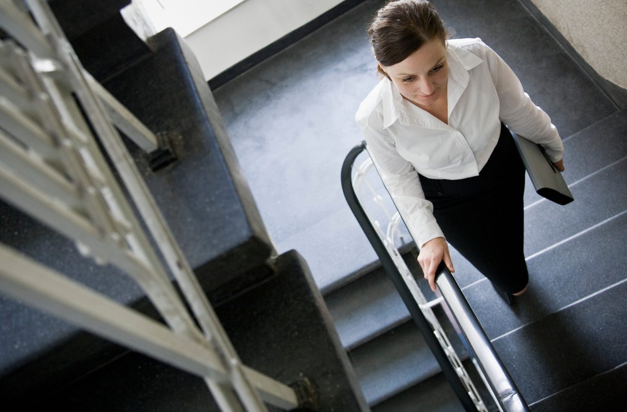 Woman walking up stairs --- Image by © Andersen Ross/cultura/Corbis