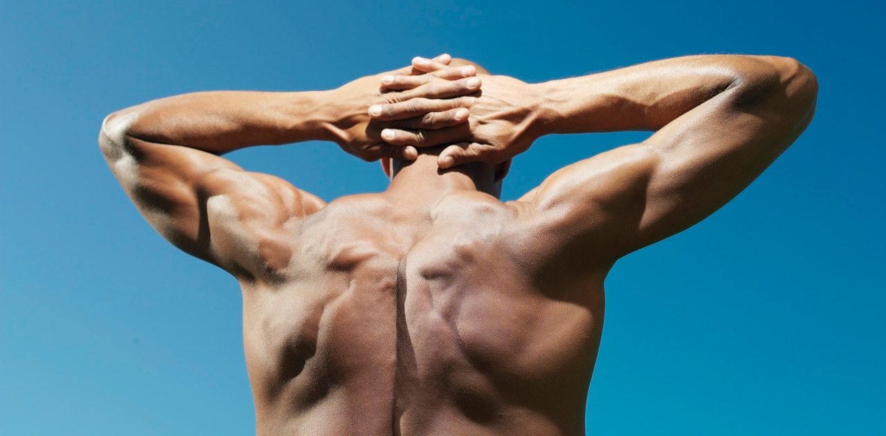 Muscular man with hands behind head --- Image by © Bernd Vogel/Corbis