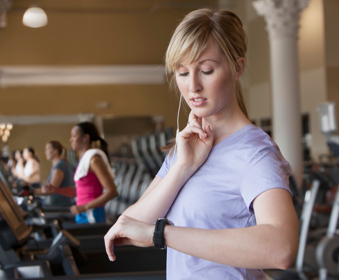 11 May 2012 --- Caucasian woman checking pulse in gym --- Image by © Jose Luis Pelaez Inc/Blend Images/Corbis