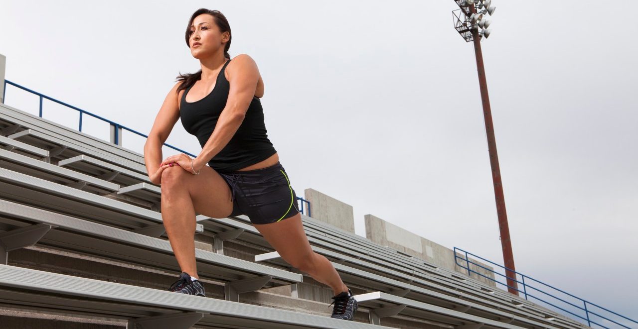 14 Sep 2011 --- Hispanic woman exercising in stadium --- Image by © John Lund/Marc Romanelli/Blend Images/Corbis