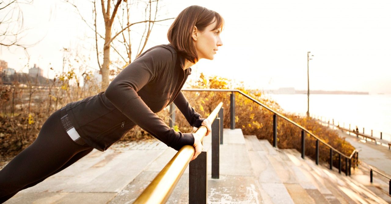 04 Dec 2012 --- Female runner working out on park railing --- Image by © Cavan Images/Corbis