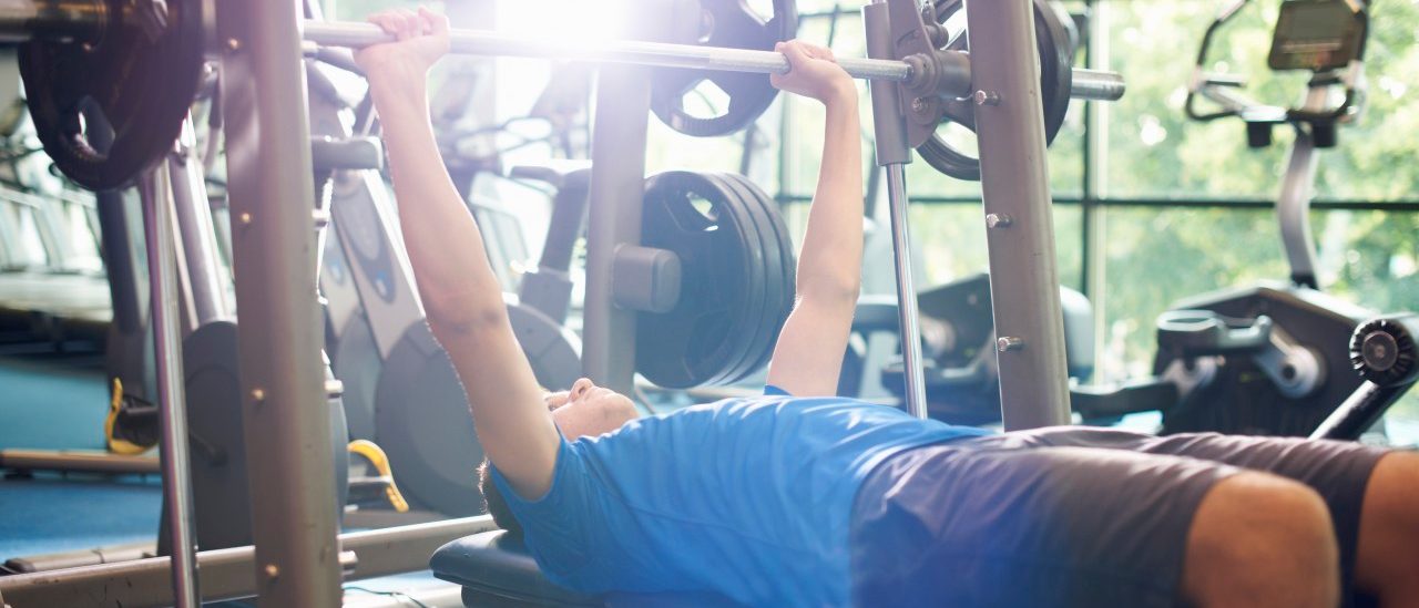 02 Jul 2014 --- Young man weight lifting with barbell --- Image by © Peter Muller/Corbis