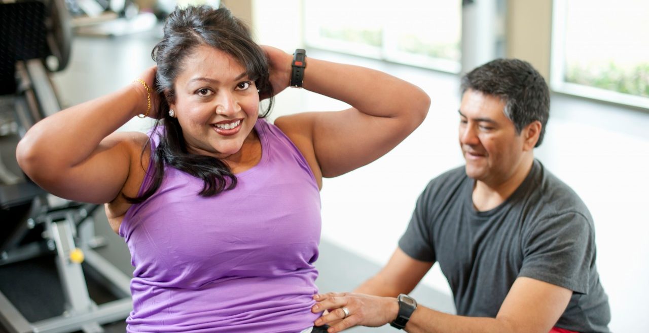 14 Mar 2012 --- Woman working with trainer in gym --- Image by © yellowdog/cultura/Corbis