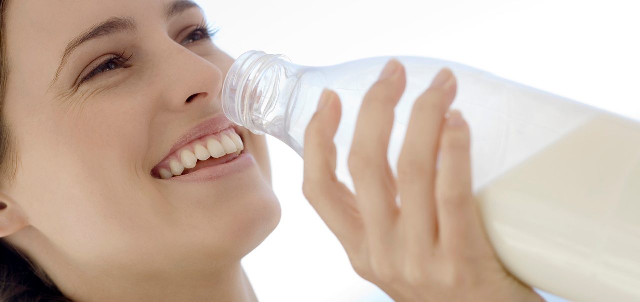 0042-11-30T00:00:00.000Z Portrait of a young woman drinking milk from the bottle, outdoors --- Image by © Elie Bernager/Onoky/Corbis