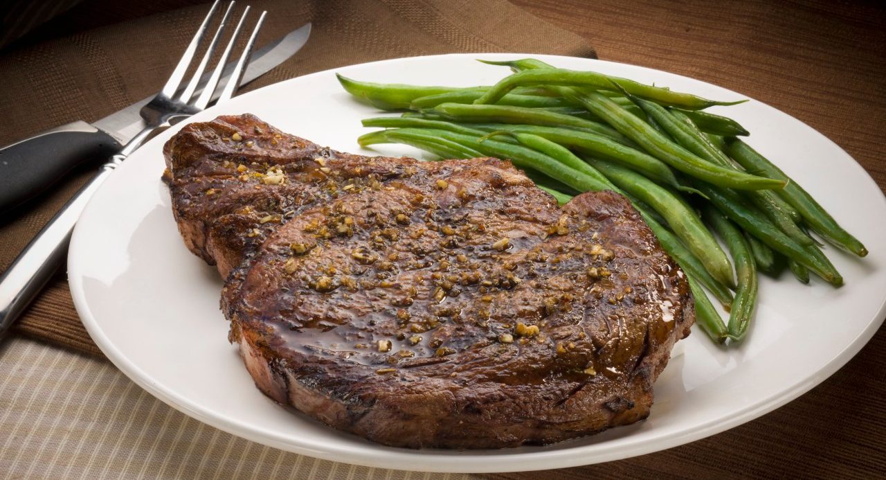 0042-11-30T00:00:00.000Z Rib-eye steak and green beans --- Image by © Rick Gayle Studio/Corbis